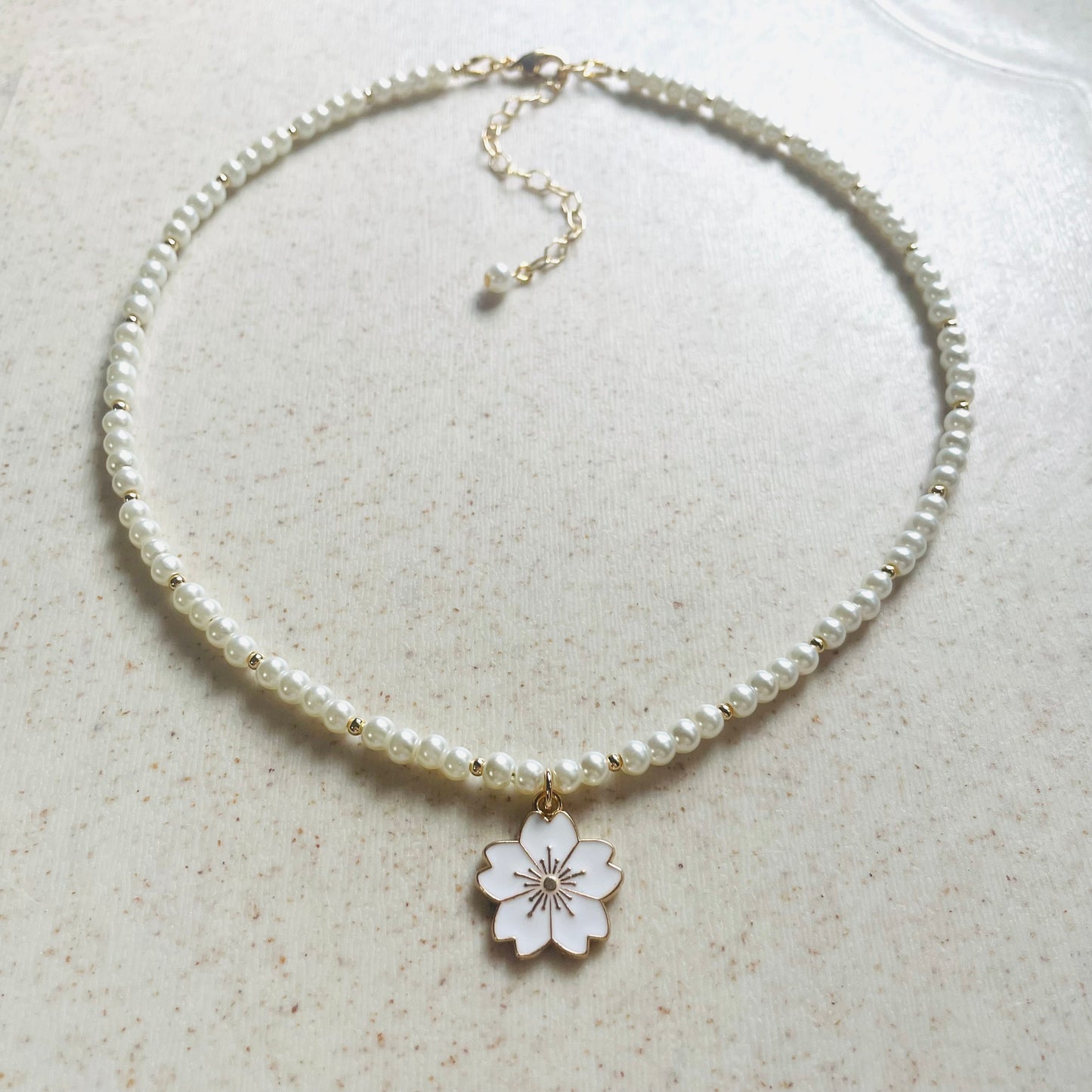 Set de collar y pulsera de perla sintética con dije flor de cerezo